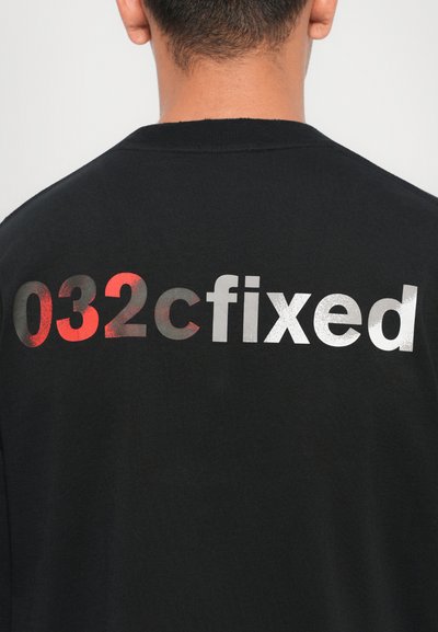 Black crewneck sweatshirt featuring a large, multi-colored print on the back with the text "032cfixed" in red and silver.