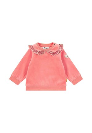 Pink velvet long-sleeve top with a ruffled collar, snap button detail, and side logo patch. Smooth texture and relaxed fit.