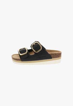 Sandalia tipo slide negra con dos grandes hebillas doradas, plantilla de corcho y suela blanca estriada, diseñada para uso casual.