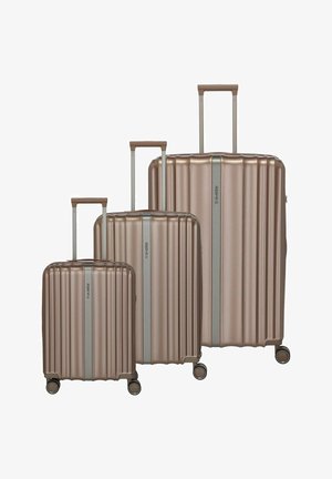 Three metallic bronze suitcases of varying sizes, featuring a ribbed design, extendable handles, and smooth-rolling wheels.