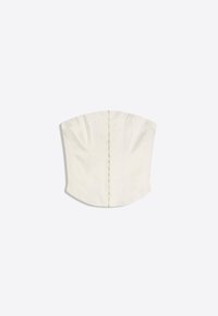 Top corset blanc sans bretelles avec fermeture à agrafes à l'avant et coutures contournées, conçu pour une silhouette ajustée.