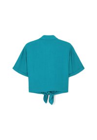 Camicetta corta a maniche corte di colore teal con colletto e un nodo legato nell'orlo posteriore, presentata su uno sfondo bianco.