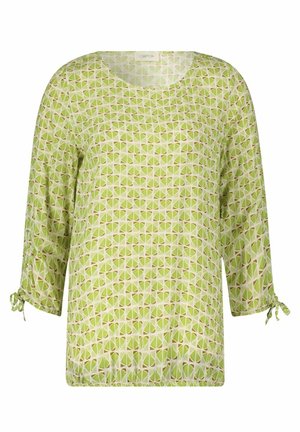 Blusa verde con motivo geometrico, dotata di maniche a tre quarti e legature regolabili ai polsini. Tessuto leggero.