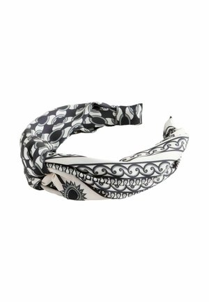 Black and white patterned twisted headband with circular and sun motifs on a white background.
