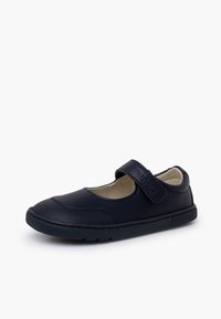 Chaussure Mary Jane noire avec bride velcro, col rembourré et semelle en caoutchouc texturée, conçue pour un usage décontracté ou scolaire.