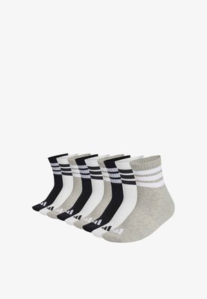 Nine pairs of ankle socks in black, white, and gray, each with two horizontal stripes near the cuff and a small logo on the toe.