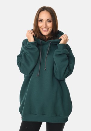 Oversized green hoodie featuring a drawstring hood and ribbed cuffs. Soft texture with a solid color and casual design.
