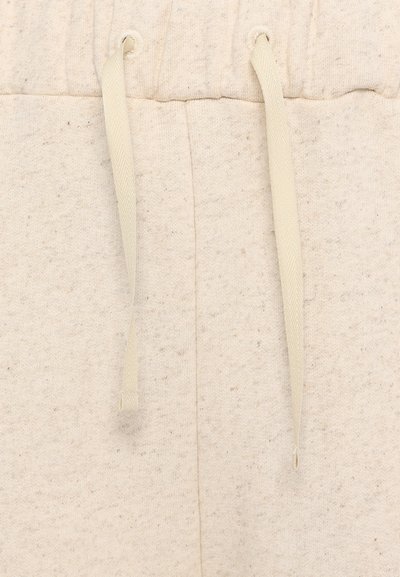 Lys beige joggebukser med strukturert stoff, elastisk midje og matchende snorer. Ideelle for hverdagsbruk og komfort.