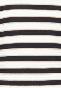 Gros plan d'un tissu tricoté avec des rayures horizontales alternées en noir, blanc et nuances de beige.