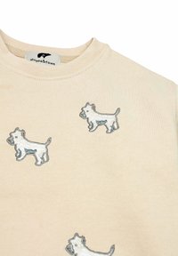 Felpa in cotone beige con scollatura rotonda, caratterizzata da cani bianchi ricamati in varie pose. Texture liscia e design casual.