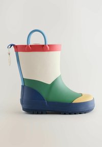 Child's rubber rain boot with blue sole and handle, cream upper, green midsection, red trim, and yellow toe cap on plain background.