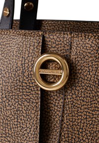 Close-up of a textured brown handbag with a circular gold clasp engraved with the brand name "Borbonese."