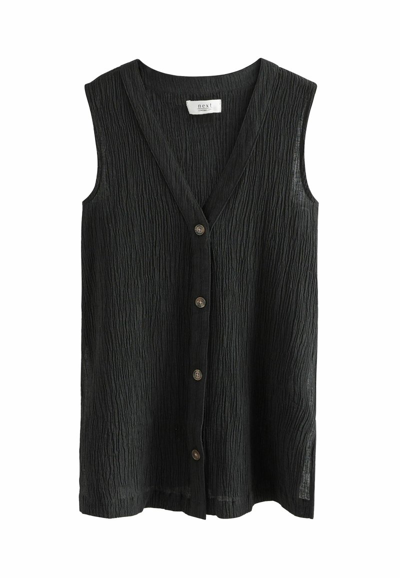 Blouse noire texturée sans manches avec col en V et quatre boutons foncés sur le devant, présentée sur fond blanc.
