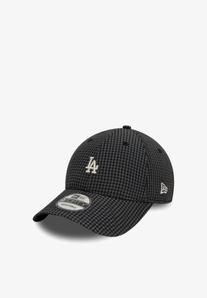 Black and gray checkered baseball cap with a curved brim, featuring an embroidered white logo on the front and an adjustable strap at the back.