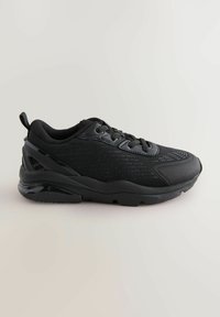 Schwarzer Sportschuh mit strukturiertem Mesh-Obermaterial, dünnen Schnürsenkeln und gepolsterter Sohle. Verfügt über einen glänzenden Fersenelement und subtile geometrische Muster.