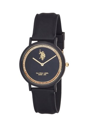 Orologio da polso nero con lancette dorate, logo del giocatore di polo dorato, lunetta tempestata di cristalli e testo "U.S. Polo Assn. Since 1890" sul quadrante.