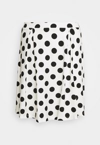 Jupe blanche à pois noirs, design plissé, tissu doux, mi-longue, avec une ceinture en haut. Motifs circulaires simples sur toute la surface.