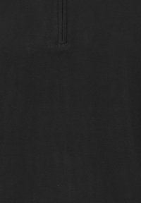 Black polo shirt, made of smooth cotton fabric, featuring a half-zip neck and a clean design without visible patterns or embellishments.