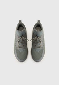 Gray athletic shoes with mesh upper, rounded toe, and contrasting rubber sole. Features laces and a pull tab on the heel for easy wear.
