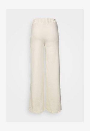 Kremne hlače širokih nogavic iz mehkega materiala; vsebujejo elastičen pas in gladko teksturo; vidne šive ob robu.