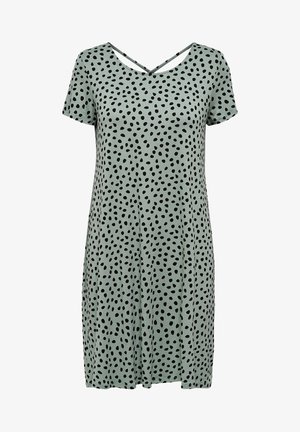 Robe vert clair à manches courtes avec pois noirs irréguliers et détail de bretelle en forme de V dans le dos.