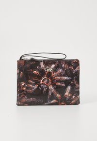 Black zippered pouch with a graphic print of spider features, including red and brown tones, a wrist strap, and a shiny logo accent.