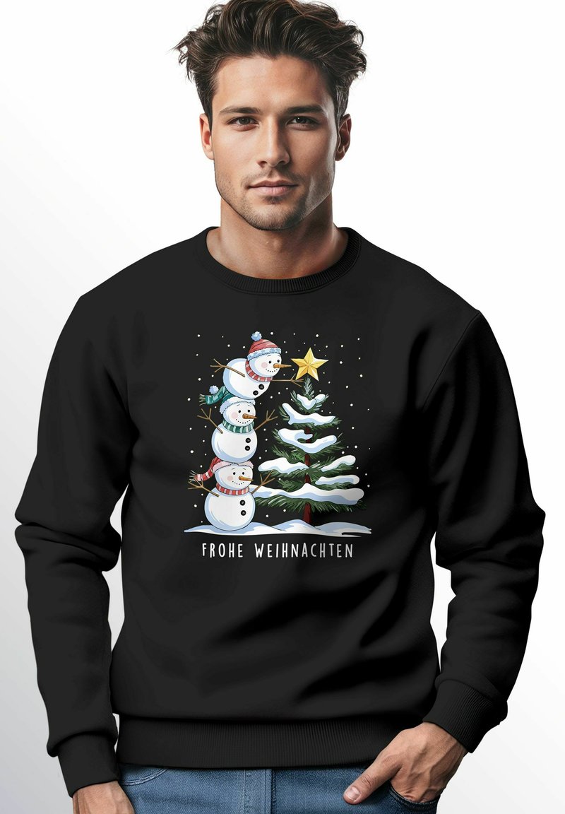 Black sweatshirt featuring a graphic of three snowmen and a Christmas tree with snow, accented by a star. Text reads "FROHE WEIHNACHTEN."