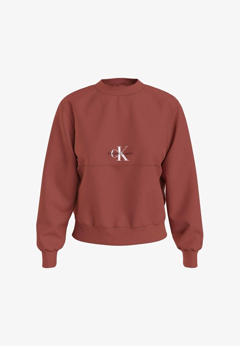 Sweatshirt i rustfarve med rund hals, lange ærmer og ribbede manchetter. Har en hvid logo på brystet. Fremstillet af blødt stof.