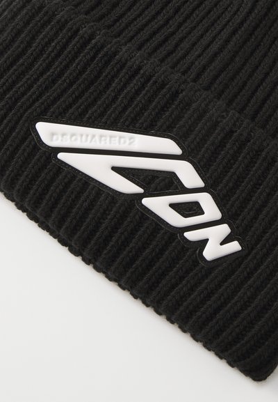 Black knitted beanie with a ribbed texture, featuring a white rubberized “ICON” logo and the brand name “DSQUARED2” prominently displayed.