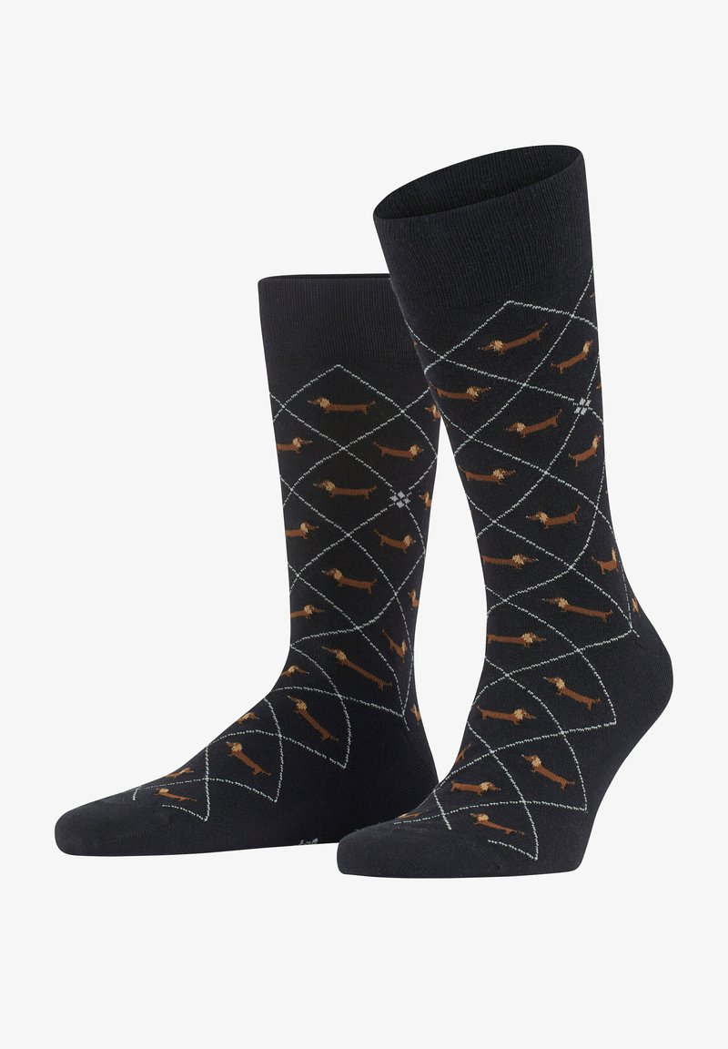 Chaussettes noires ornées d'un motif en losanges avec de petits teckels marron. Fabriquées dans un matériau doux avec un haut côtelé et un orteil renforcé.