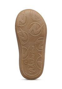 Suola di scarpa in gomma color tan con pattern di grip testurizzato che presenta un logo e elementi di design circolari. Bordo liscio e profilo piatto.