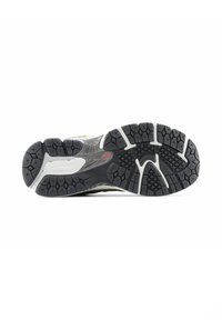 Athletic shoe outsole featuring a mixed color design in black and gray, with hexagonal traction patterns and white accents.