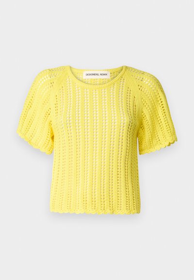 Top de punto amarillo brillante de manga corta con un patrón de tejido abierto y dobladillo ondulado. La etiqueta dice "DESIGNERS REMIX" dentro del cuello.