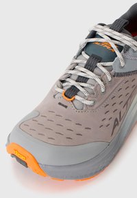 Gray and orange Altra running shoe front with white speckled laces, mesh tongue, and Vibram sole detail on white background.