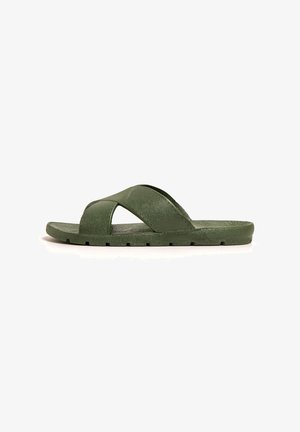 Green slide sandals made of textured synthetic material, featuring cross straps and a flat sole with a slightly raised edge.