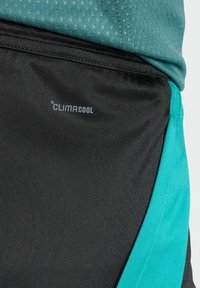 Black athletic shorts with a teal side panel and a "CLIMACOOL" logo. Fabric is smooth, designed for moisture management and breathability.