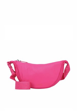 Pink fabric crossbody bag with a curved shape, featuring a zip closure, woven logo strap, and smooth texture. Brand name embossed on the front.