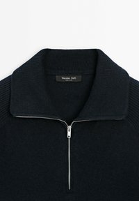 Dark navy sweater with a ribbed collar, half-zip front, and a smooth texture. Features a logo label inside the collar.