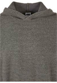 Grau sweatshirt mit Kapuze aus strukturiertem Stoff mit einem dezenten Muster, mit einem Etikett im Kragen innen. Einfaches und lässiges Design.