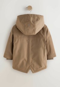 Brown hooded jacket with a smooth, water-resistant exterior, featuring a front seam and short sleeves, hung on a wooden hook.