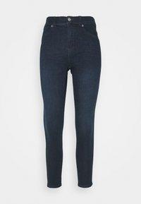 Vaqueros ajustados azul oscuro con cintura alta, diseño de cinco bolsillos, cierre de botón metálico y un ligero desvanecimiento a lo largo de las piernas. Tela de denim clásica.
