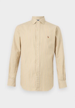Camicia beige a maniche lunghe con bottoni, con righe verticali bianche e piccolo logo ricamato sul lato sinistro del petto.