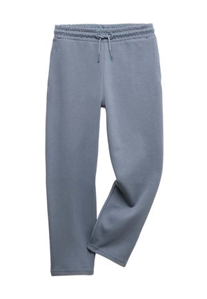 Pantalon de survêtement bleu clair avec ceinture élastique et cordon de serrage, une jambe croisée sur l'autre, présenté sur fond blanc.
