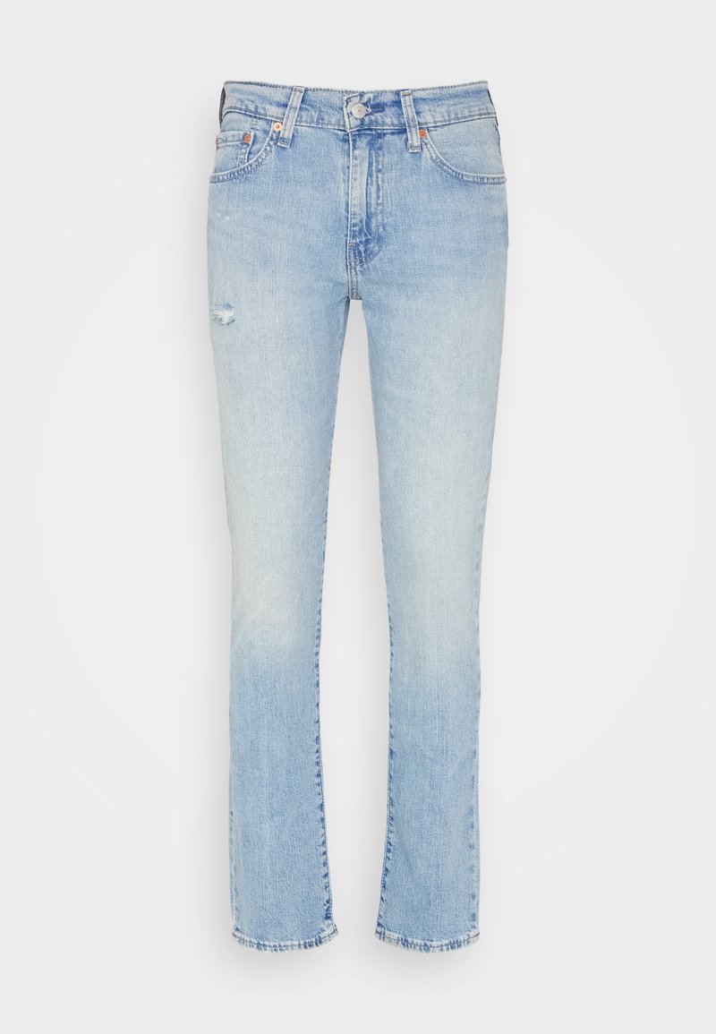 Jeans in denim azzurro con una vestibilità dritta, caratterizzati da lievi abrasioni sulla parte anteriore e un orlo sfilacciato. Design a cinque tasche con dettagli in metallo.