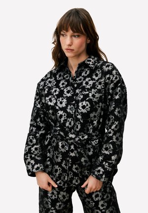 Zwart en zilver bloemmotief overhemd met een kraag en lange mouwen. Voorzien van een tailleband en een gestructureerde stof.