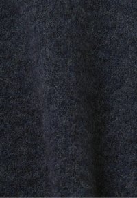 Dunkelblaues Wollgewebe mit einer strukturierten Oberfläche, das ein weiches, flauschiges Finish und subtile Farbvariationen für Tiefe aufweist.