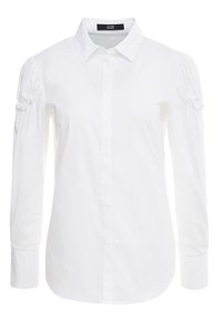 Camicia bianca con bottoni, maniche lunghe con dettagli arricciati, colletto tradizionale e orlo arrotondato. Tessuto morbido al tatto.