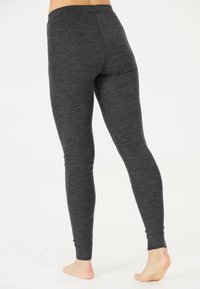 Schwarze Leggings aus strukturiertem Stoff, mit einem hohen Bund und einem figurbetonten Design, das sich an den Knöcheln verjüngt.