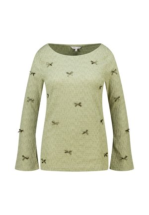 Lichtgroen shirt met lange mouwen en een subtiele textuur, versierd met kleine donkergroene strikjes verspreid over de voorkant en mouwen.