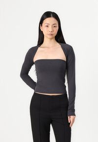 Long-sleeve top in dark gray, featuring a wide square neckline and fitted design, paired with black straight-leg trousers. Smooth fabric texture.